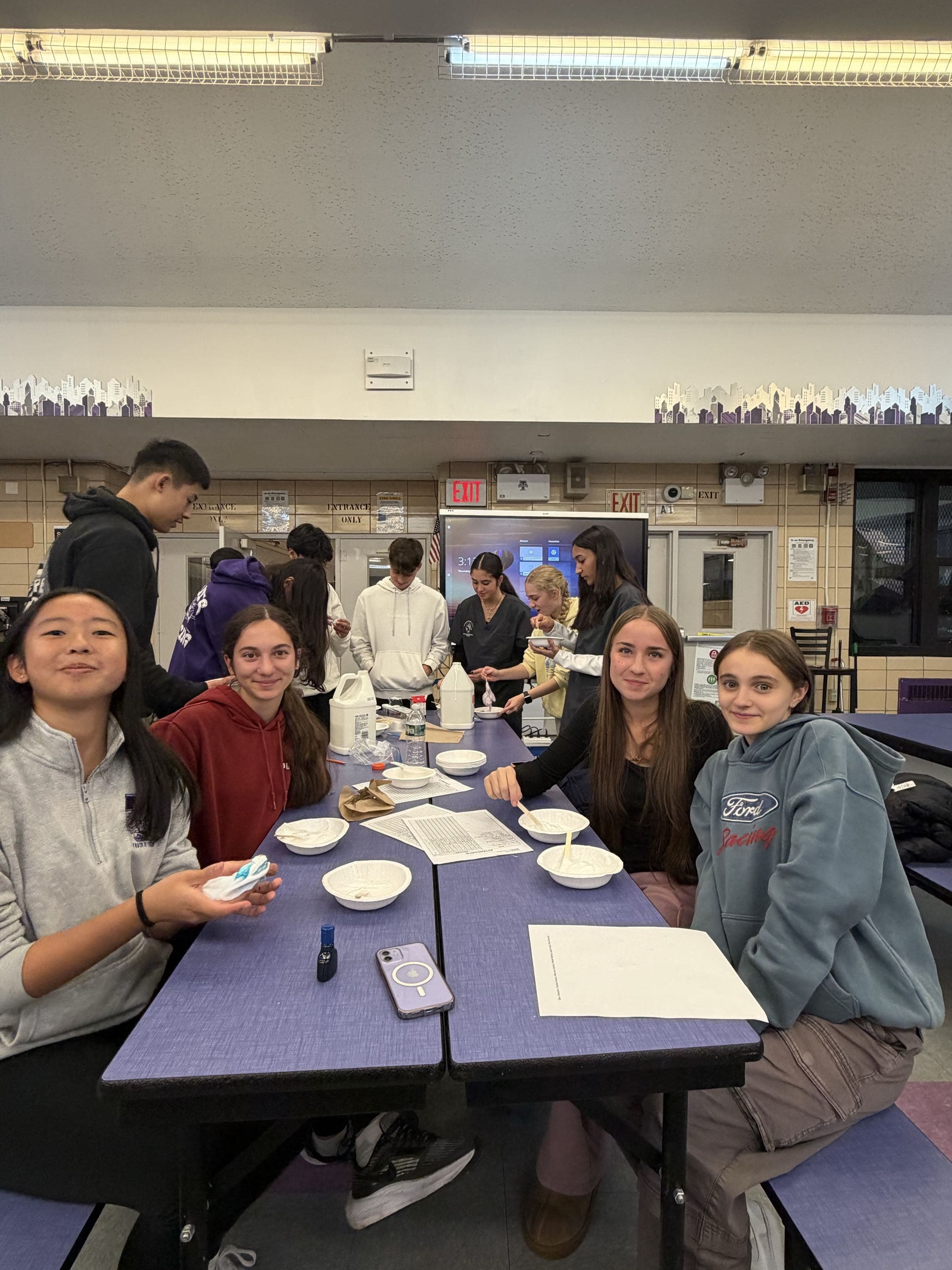 Students making slime during a chemistry club lab activity